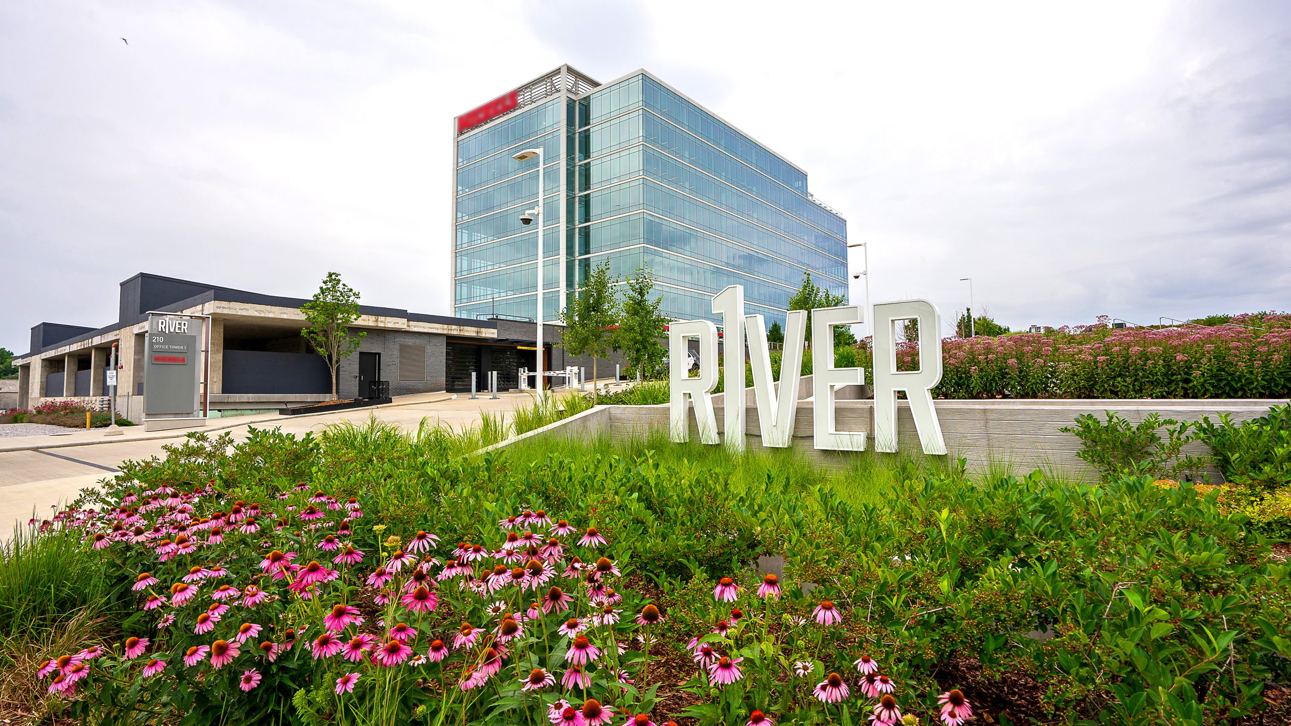 R1ver landscape maintenance with tiered native plant beds designed for rainwater capture