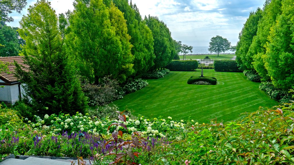 Garden maintenance of colorful flower beds and water feature at Villa Terrace
