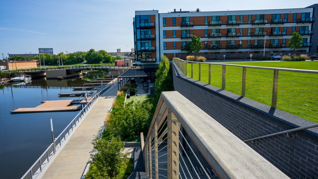 Riverwalk stairs leading toward café with manicured turf and planting