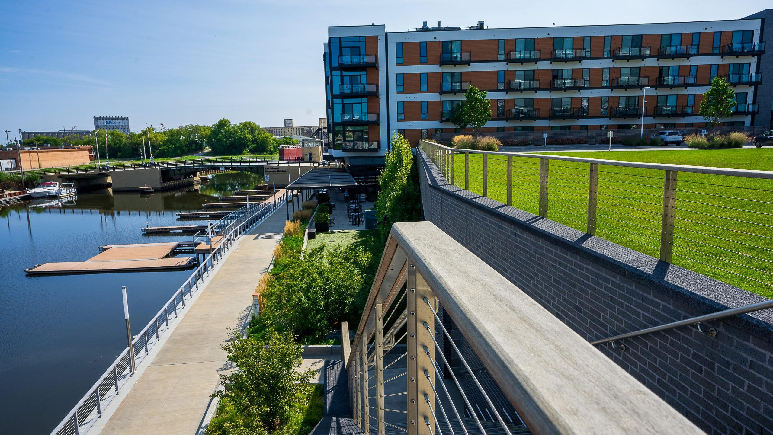 Riverwalk stairs leading toward café with manicured turf and planting